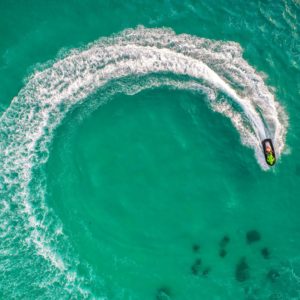 People are playing jet ski at sea during the holidays. And beautiful nature backdrop.